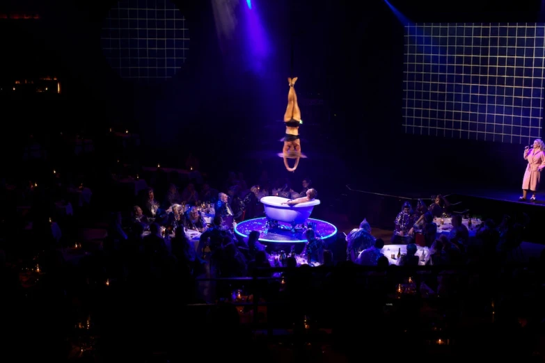 one woman performs on a stiltsheet with a man on top