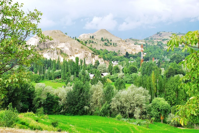 the mountains are behind the small village on a hillside