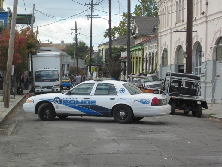 a police car that is driving through the street