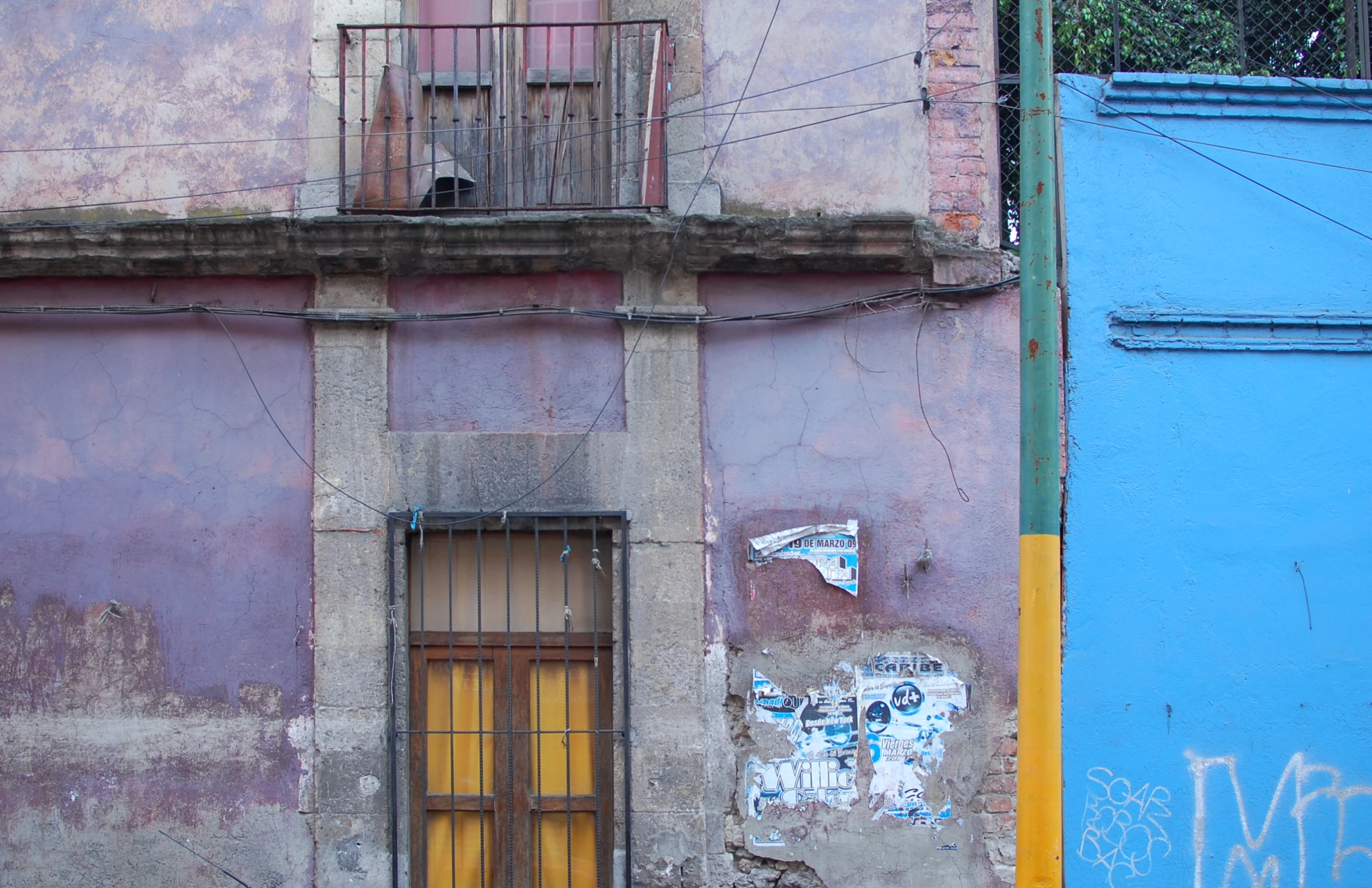 old and dilapidated buildings with a cat sitting on the doorway