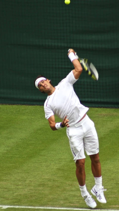 a tennis player who is hitting a ball with his racket