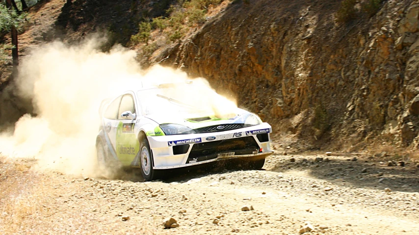 a car that is going down a dirt road