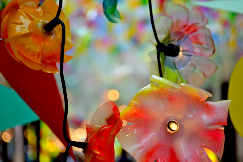 different colored handmade ornaments hanging from strings