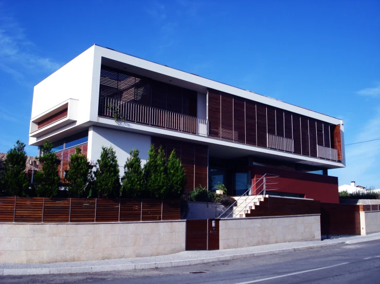 a modern building with tall columns and wooden doors