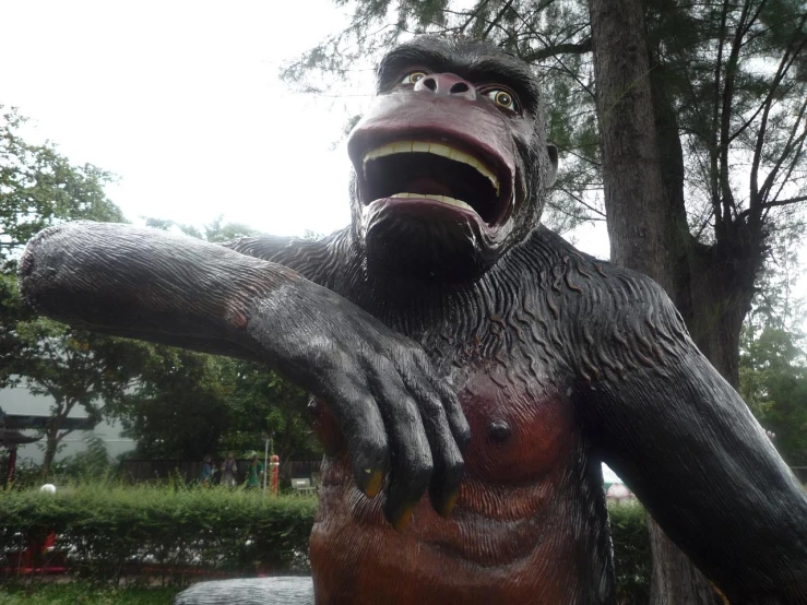 an iron statue of a giant man like creature holding his hand out