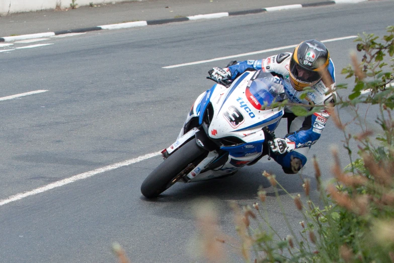 a man rides a racing bike along the road