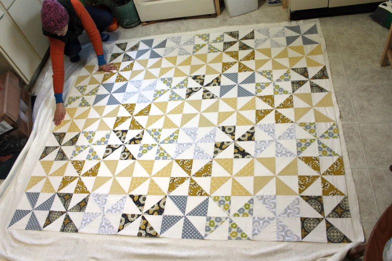 someone is working on the quilt in the kitchen
