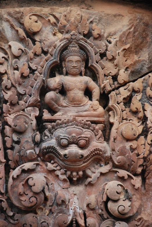 carved stone with a buddha on it and several circles around it