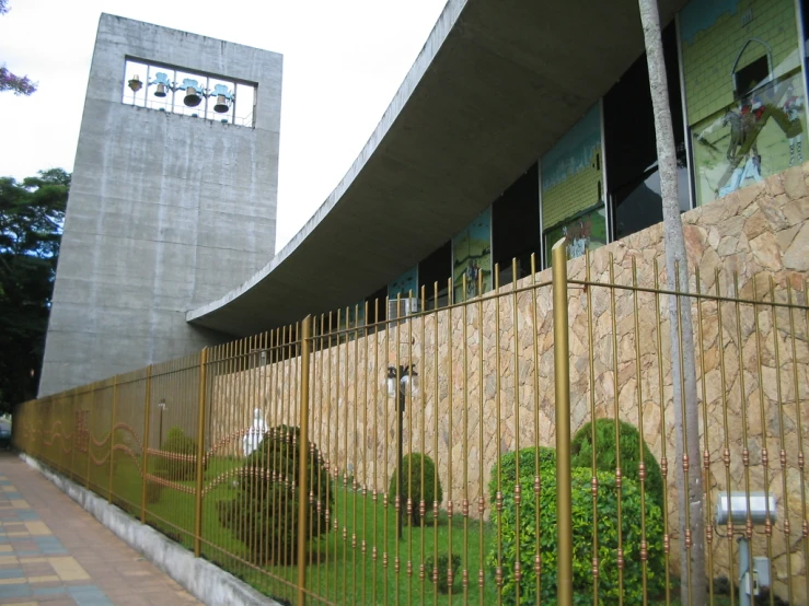 a building with a clock tower sits next to the grassy yard