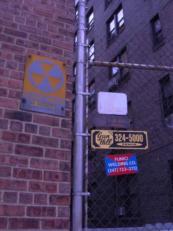 a bunch of signs on the corner of a street