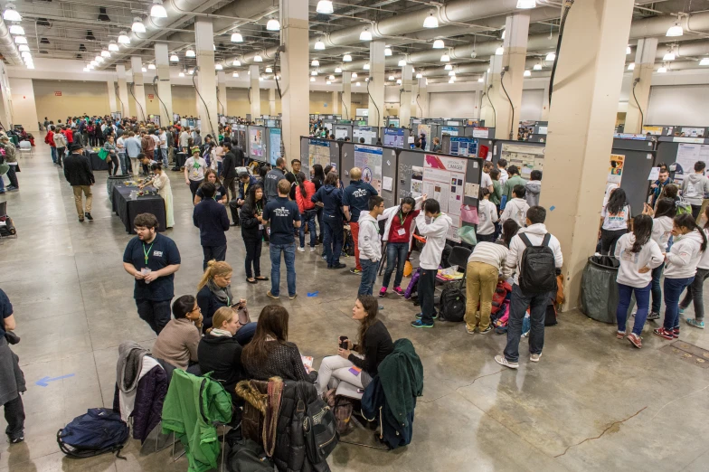 a large group of people in a room with luggage