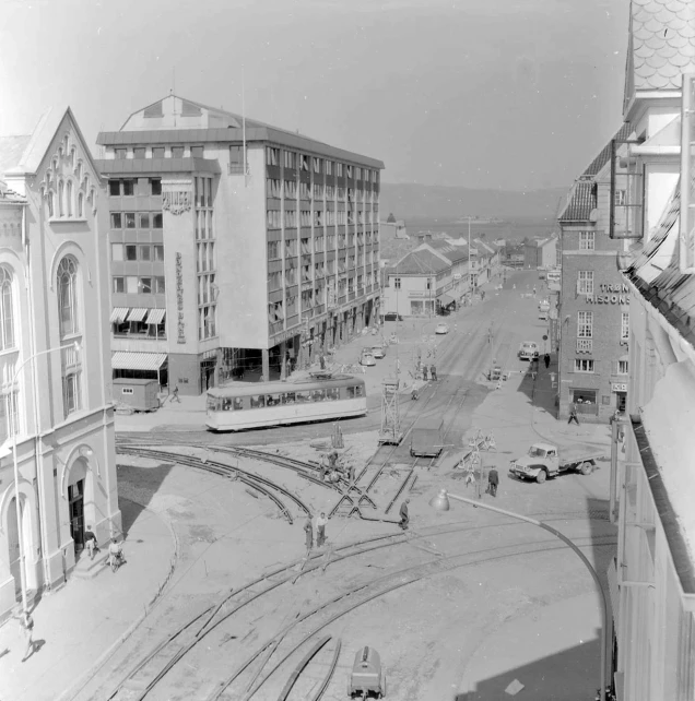 a black and white po of train tracks next to buildings