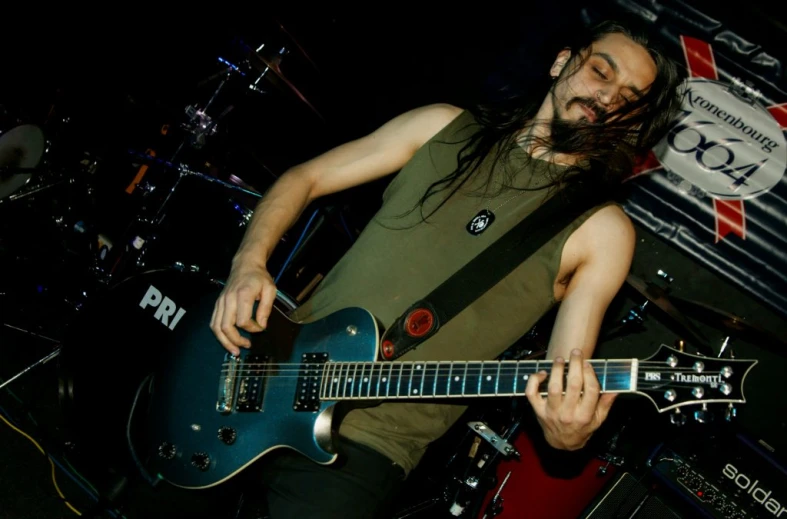 a man with long hair and a guitar