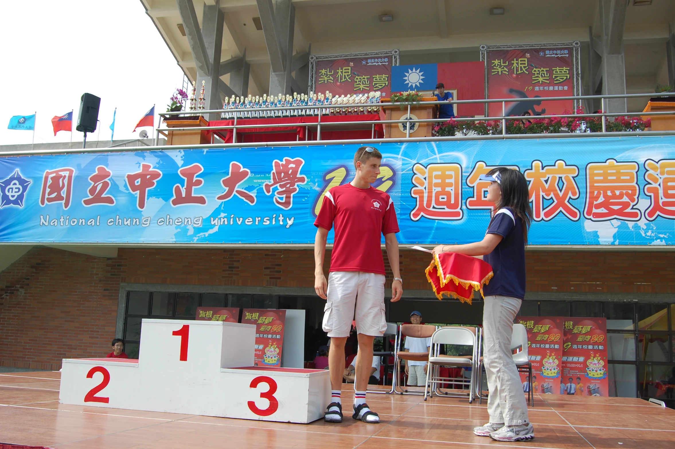 two girls on a stage with a banner and number