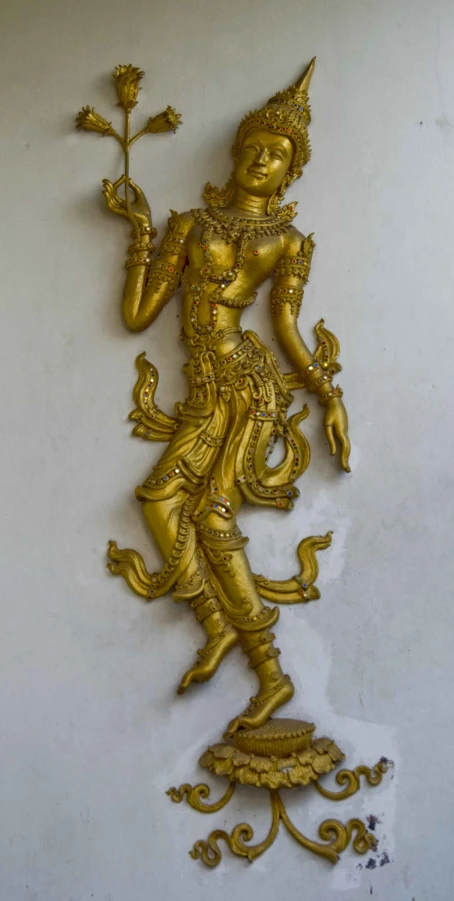 ss statue of the hindu god holding a plant