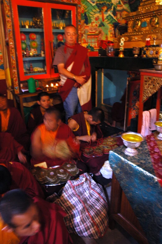 a group of people sitting around a table with plates on it