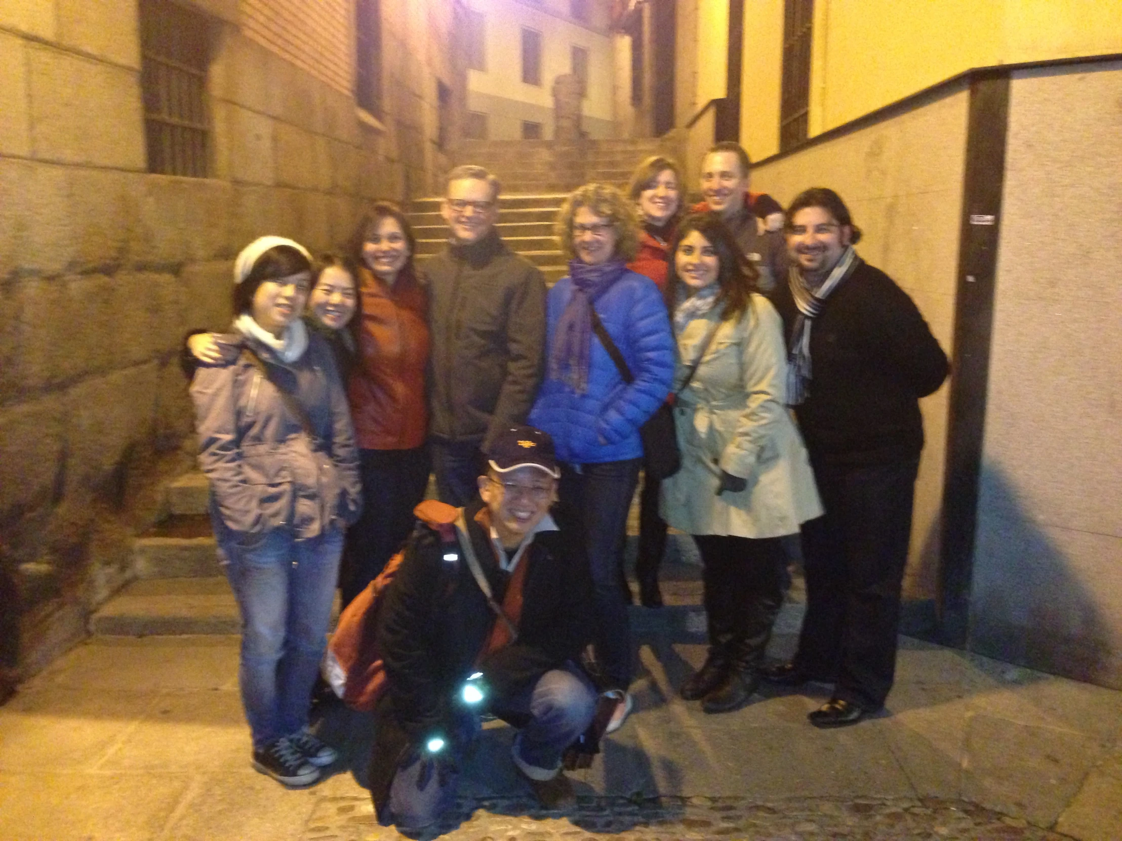 a group of people standing on the side of a street