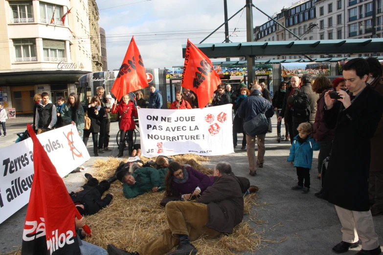 a group of people holding up red and white signs