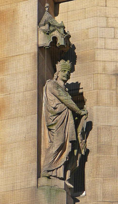 a statue stands on the outside of a building