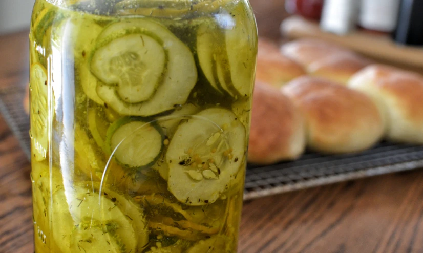 there is a jar filled with sliced cucumbers