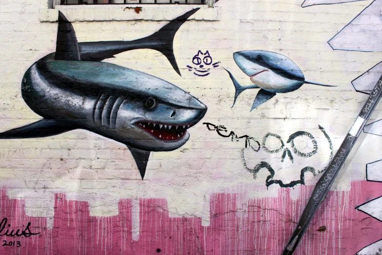 graffiti on a wall of a shark and other things