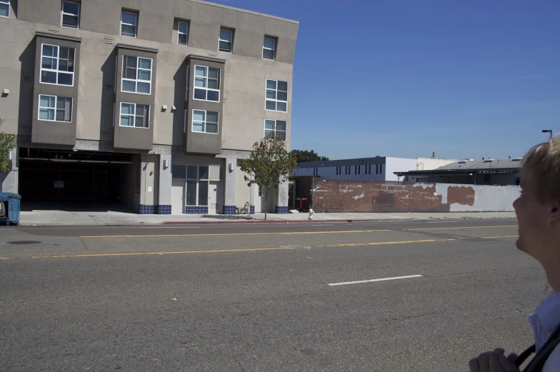 a large tan apartment building sitting in front of a tall blue truck