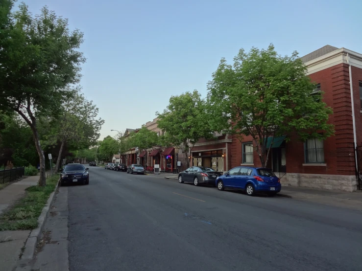 several cars are parked in a quiet street