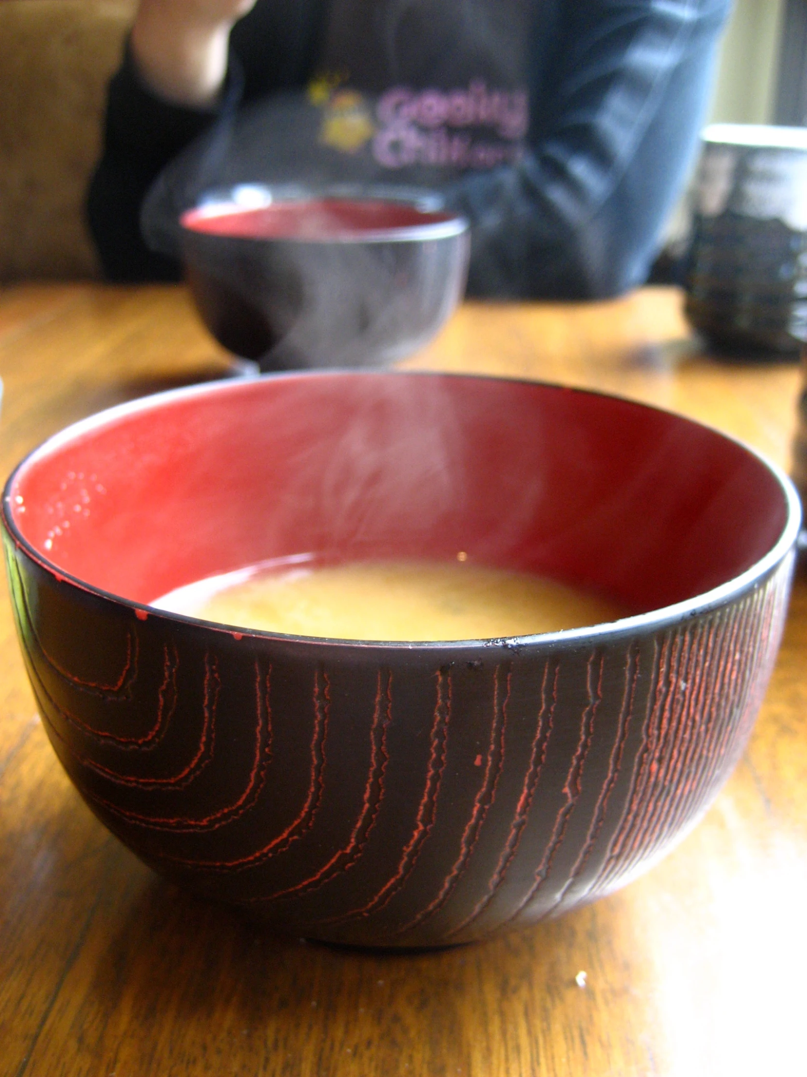 a bowl of soup with steam rising from the top