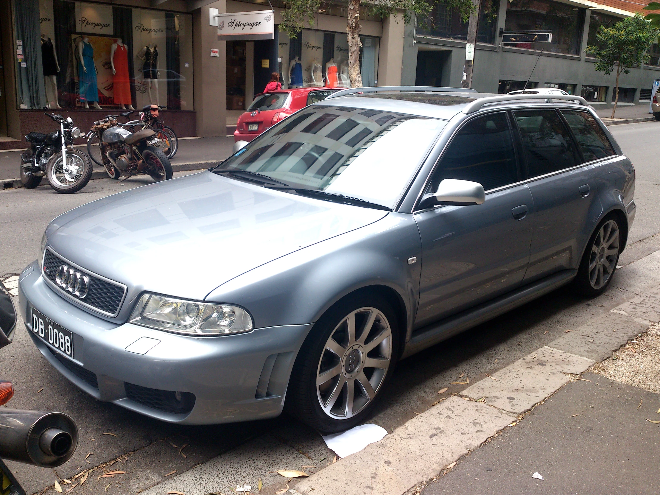 a grey car parked on the side of a street