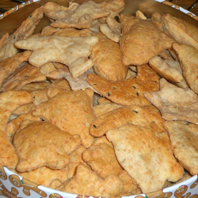 some chips are piled into a white and brown bowl