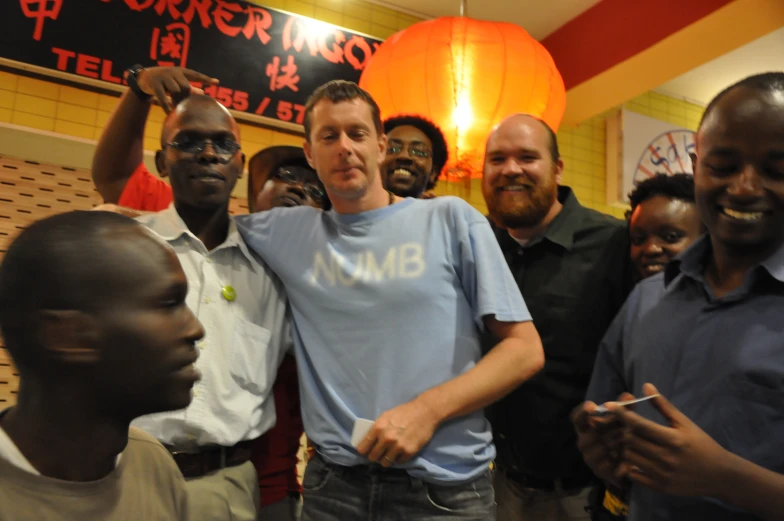 a man stands with a group of people in a restaurant