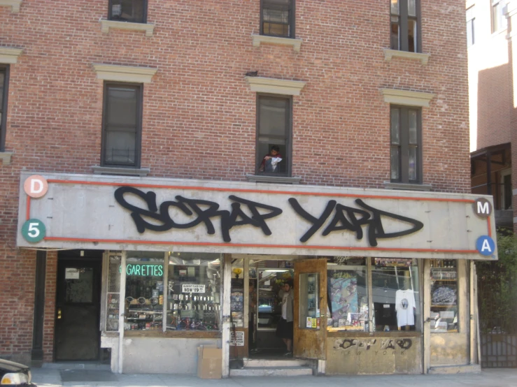 people are seen looking out the window of a store