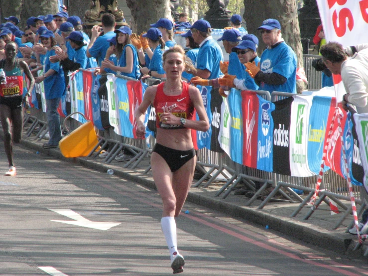 a marathon race with one female running in the opposite direction