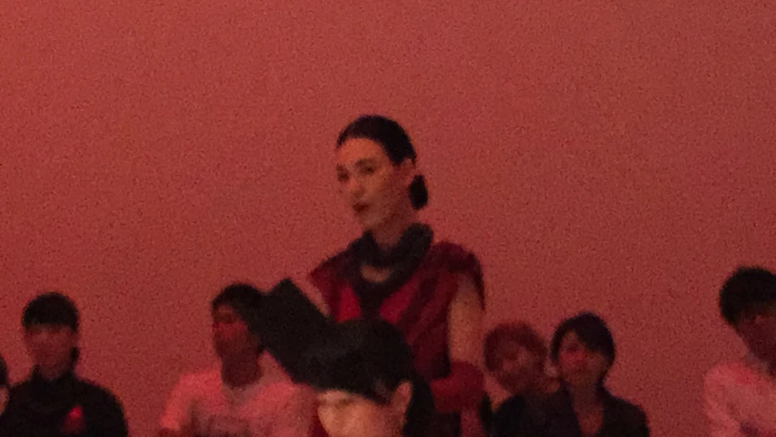 the woman is wearing a dark red dress and has black hair on her head