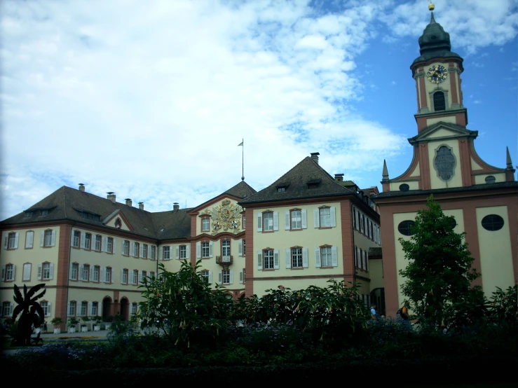 large building with clock tower in middle of courtyard