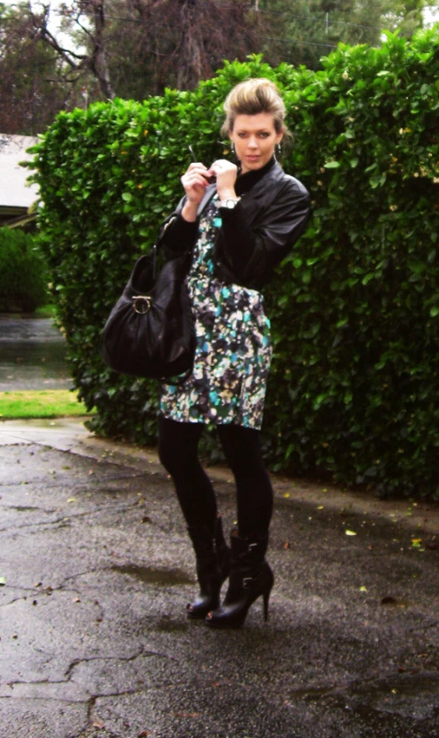 a beautiful woman holding an umbrella on a rainy day