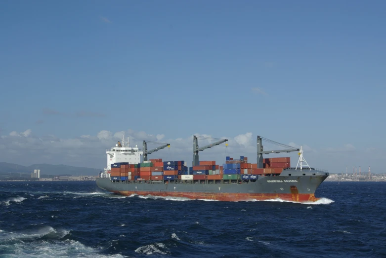 a cargo ship loaded with containers on it's side in the ocean