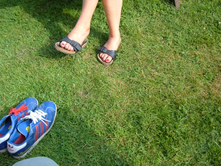 two people standing on top of green grass