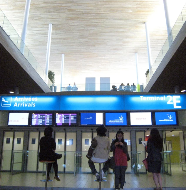 a group of people waiting for their flight in an airport