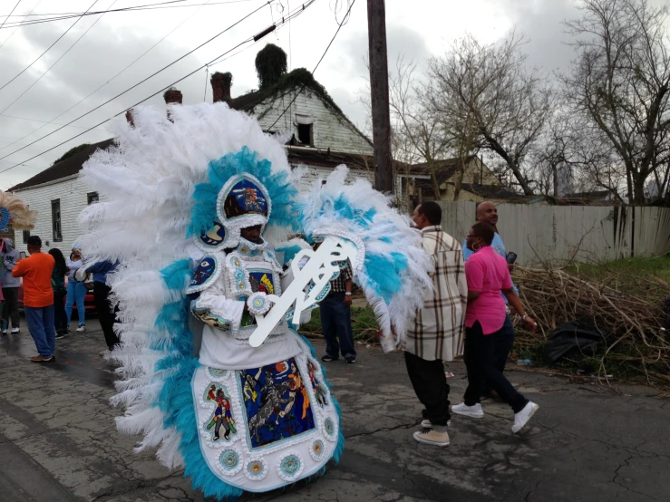 a man is wearing a blue and white costume