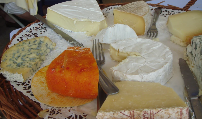 several types of cheese are on a doily