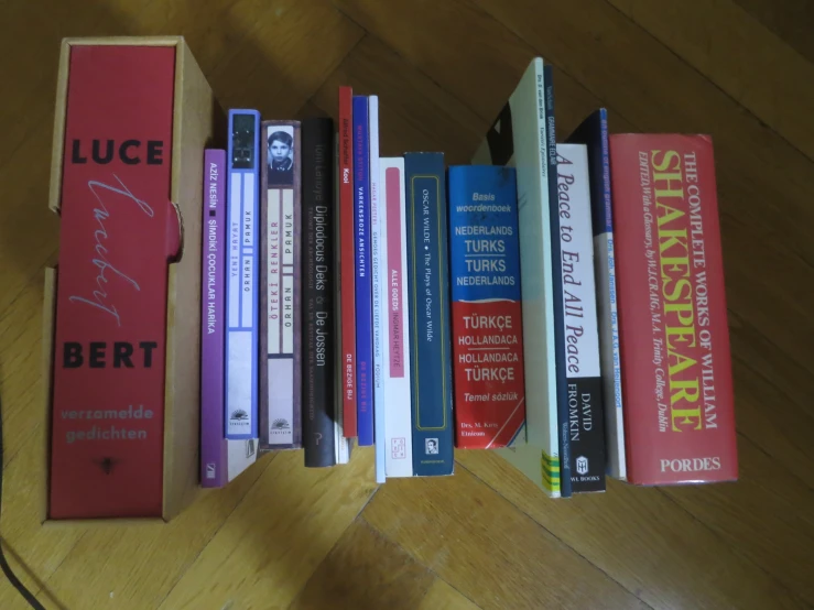 a collection of books sit next to each other on a table