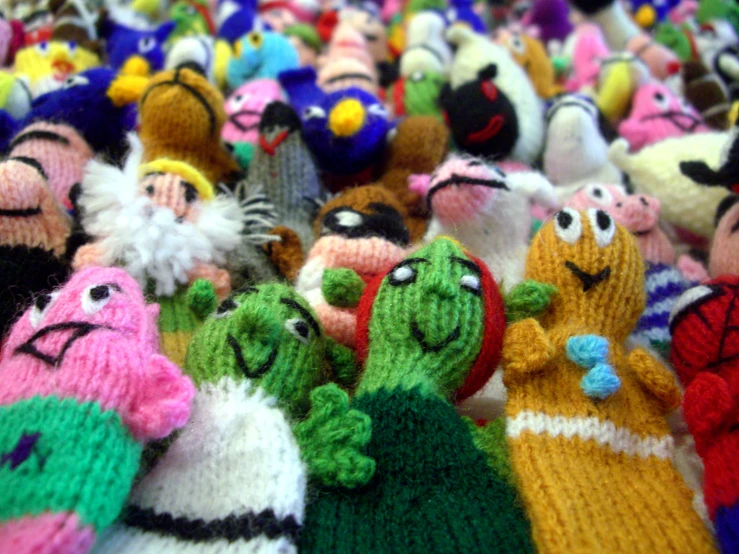 a group of multi colored knitted toy animals