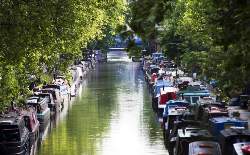 a view down a canal with boats lined along it