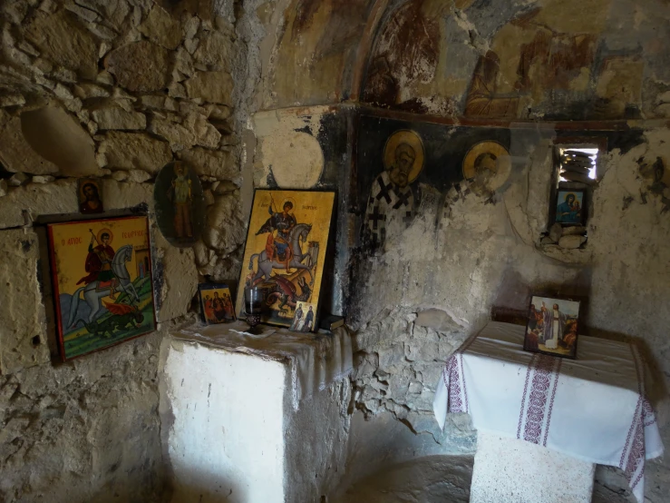 an older stone walled church with paintings on the wall