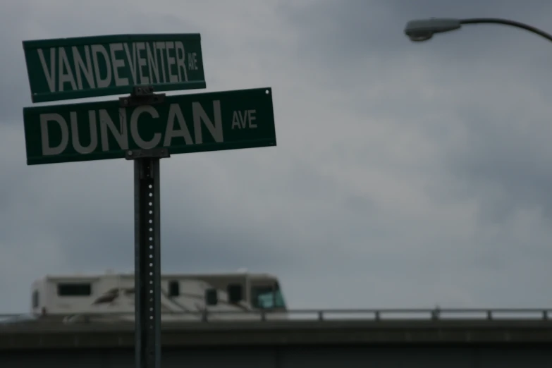 a street sign that is under a stoplight