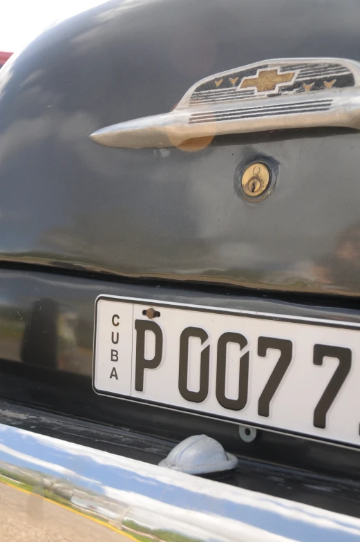 an old car is parked with its license plate