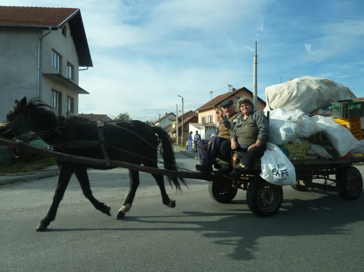 a man is riding in a cart that has a horse pulling it