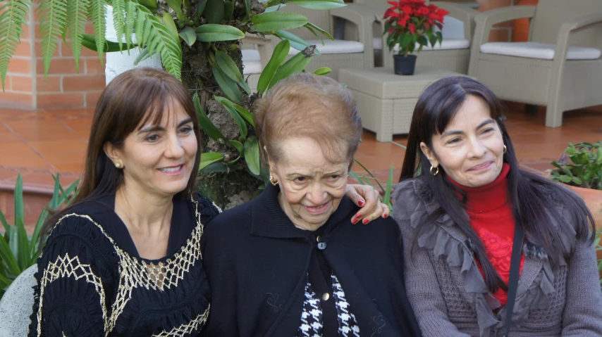 three women are smiling for the camera