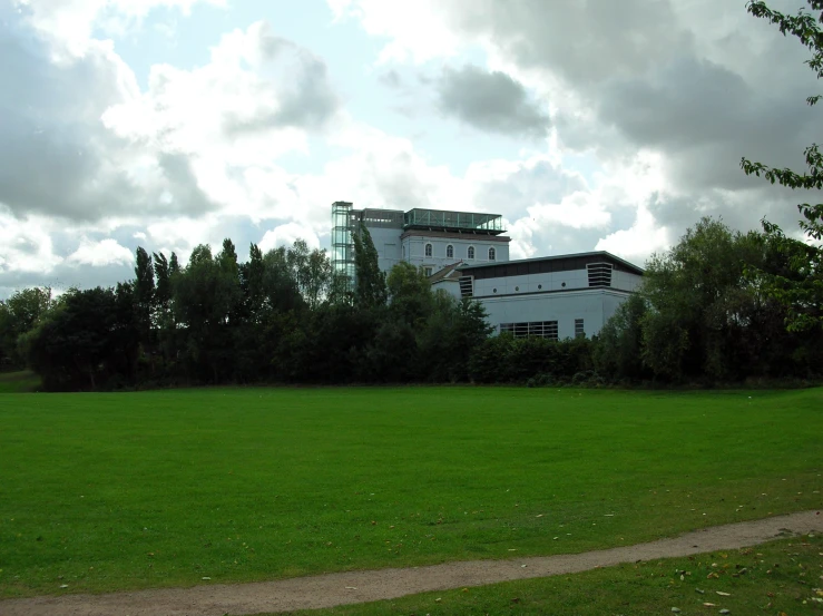 a field is shown with a house in the background